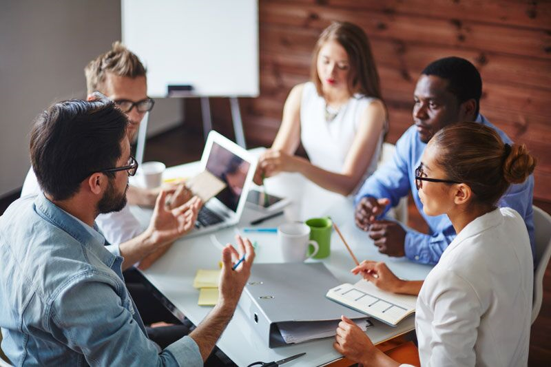 women and men at meeting, universities scored highest for gender equality